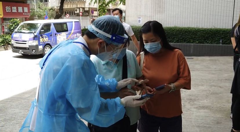 UM volunteers help with registering residents waiting for a COVID-19 test