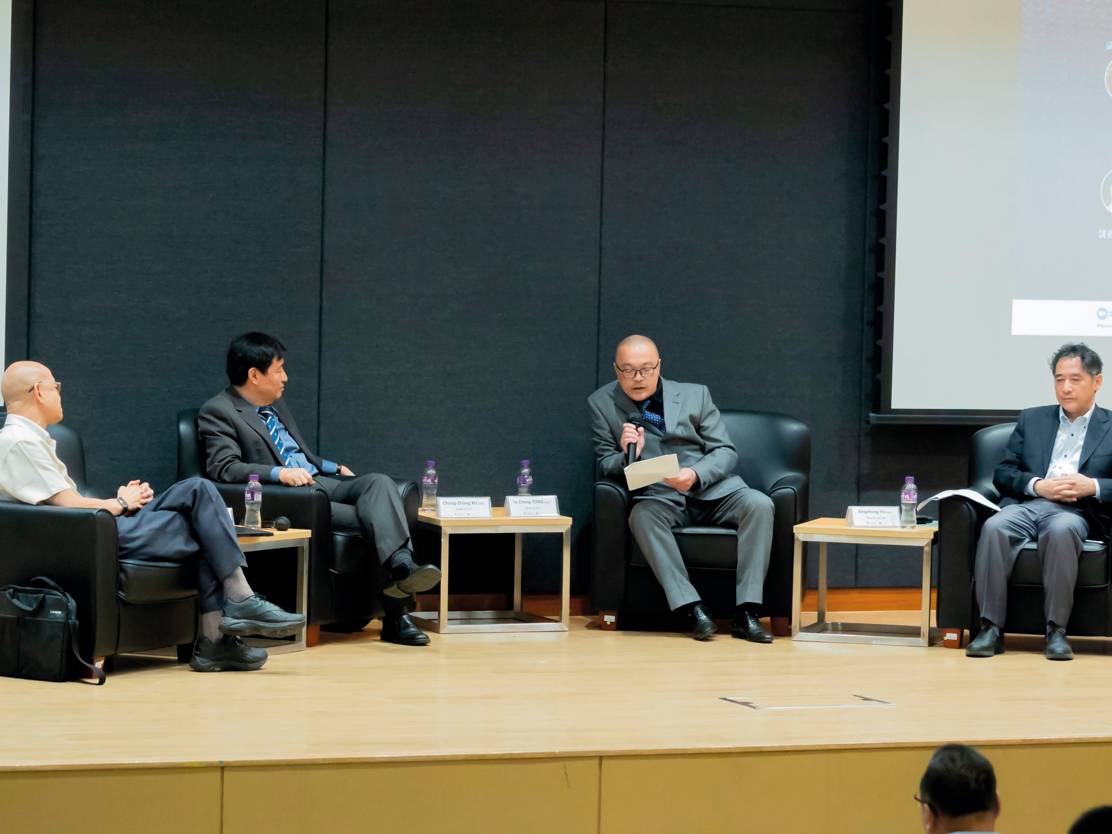 Prof Yu Xingzhong (right) moderates a roundtable discussion on the societal implications of large language models