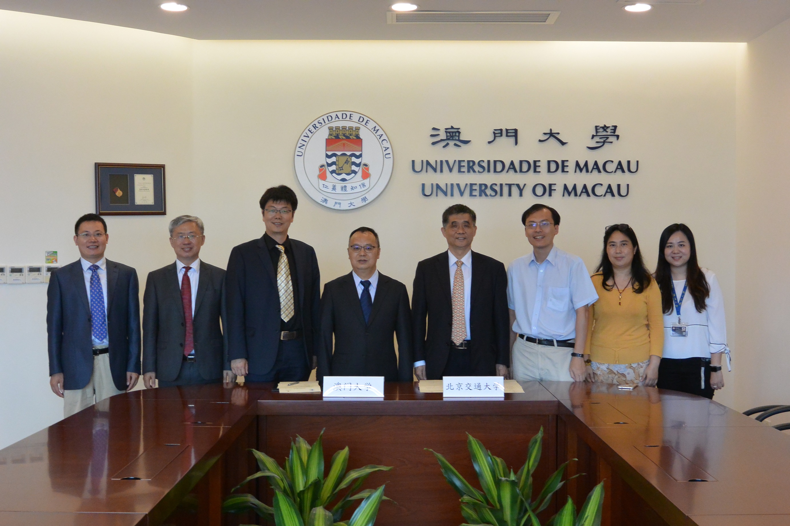 A group photo of representatives from both universities after the signing of the agreement